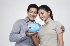 couple holding piggy bank and smiling