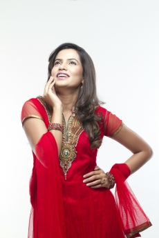 beautiful young woman posing in red indian traditional dress