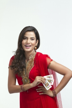 woman posing happily with cards