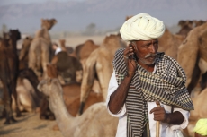 rural mean wearing turban talking on phone 