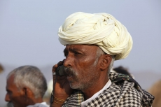 rural mean wearing turban talking on phone 