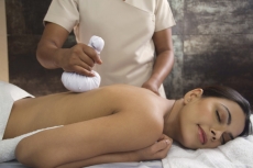 woman loving back treatment at spa center 