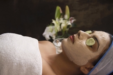 girl lying down with facepack on her face 