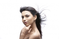 young girl with beautiful skin touching her face