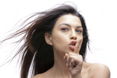 beautiful woman with finger on lips