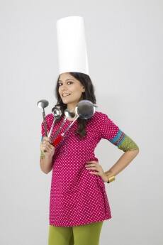 girl posing with kitchen utensils