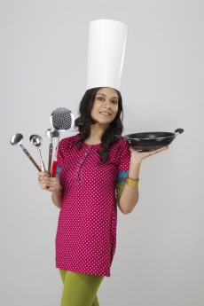 portrait of a cheerful woman holding a non stick pan