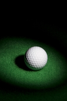 a golf ball on a green surface