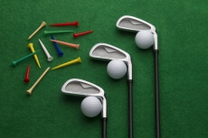 different golf accessories on green background