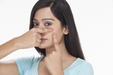 close-up on the face of a young female showing her acne