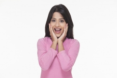 surprised woman with her hands on face 