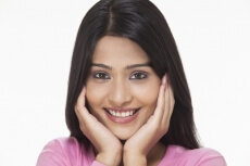 woman posing with hands on her face in awe