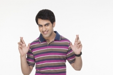 young man posing with fingers crossed