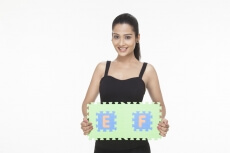 girl smiling and posing with jigsaw puzzle