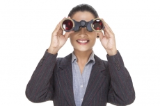 young businesswoman watching with binocular 