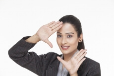 indian businesswoman framing with hands while posing for the camera 