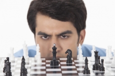 man thinking while playing chess 