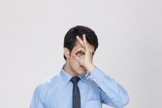 man posing while looking through hand hole 