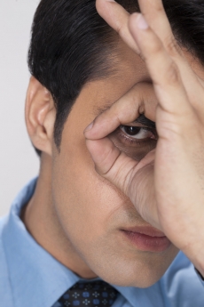 man focused by hand hole