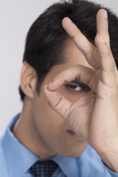 man looking through hand hole