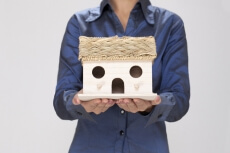close up of a girl holding home miniature 