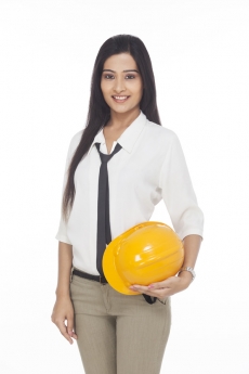girl holding hardhat and posing