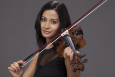violinist playing violin and smiling