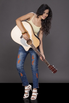girl playing guitar and looking away