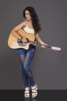 girl looking away and playing guitar