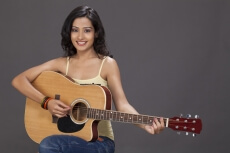girl playing guitar and posing 
