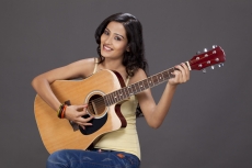 girl playing guitar and posing 