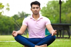 boy meditating in park