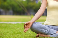 half portrait of a woman doing padmasana