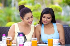 girls sitting on a breakfast table