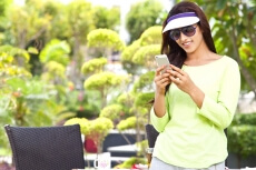 girl looking into her phone and smiling 