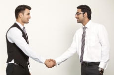 men in formals shaking hands