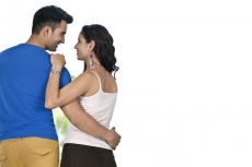 couple standing by window side 