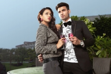 couple standing with wine glasses 