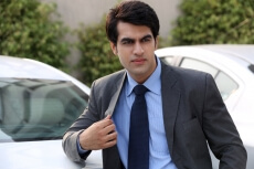 man posing with a car