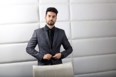 man posing in formals at work