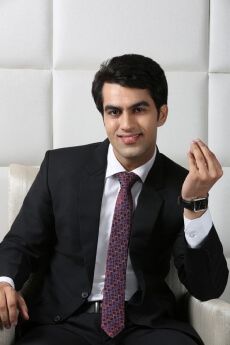 man sitting and posing in formals