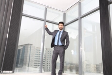 man happily posing in formal attire