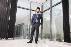 man standing with hands in pockets