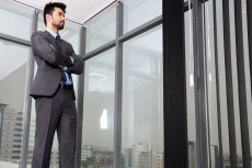 man standing at the office corridor 