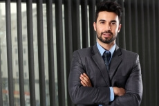 man in formal attire smiling and posing 