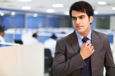 man fixing his tie
