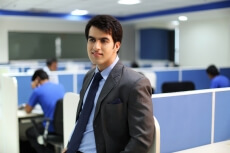 man in formal clothing leaning