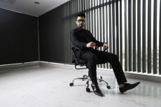 man in formals sitting and posing
