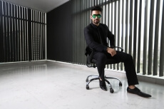 man sitting and posing in formals