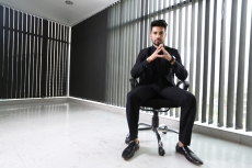 man sitting and posing in formals 
